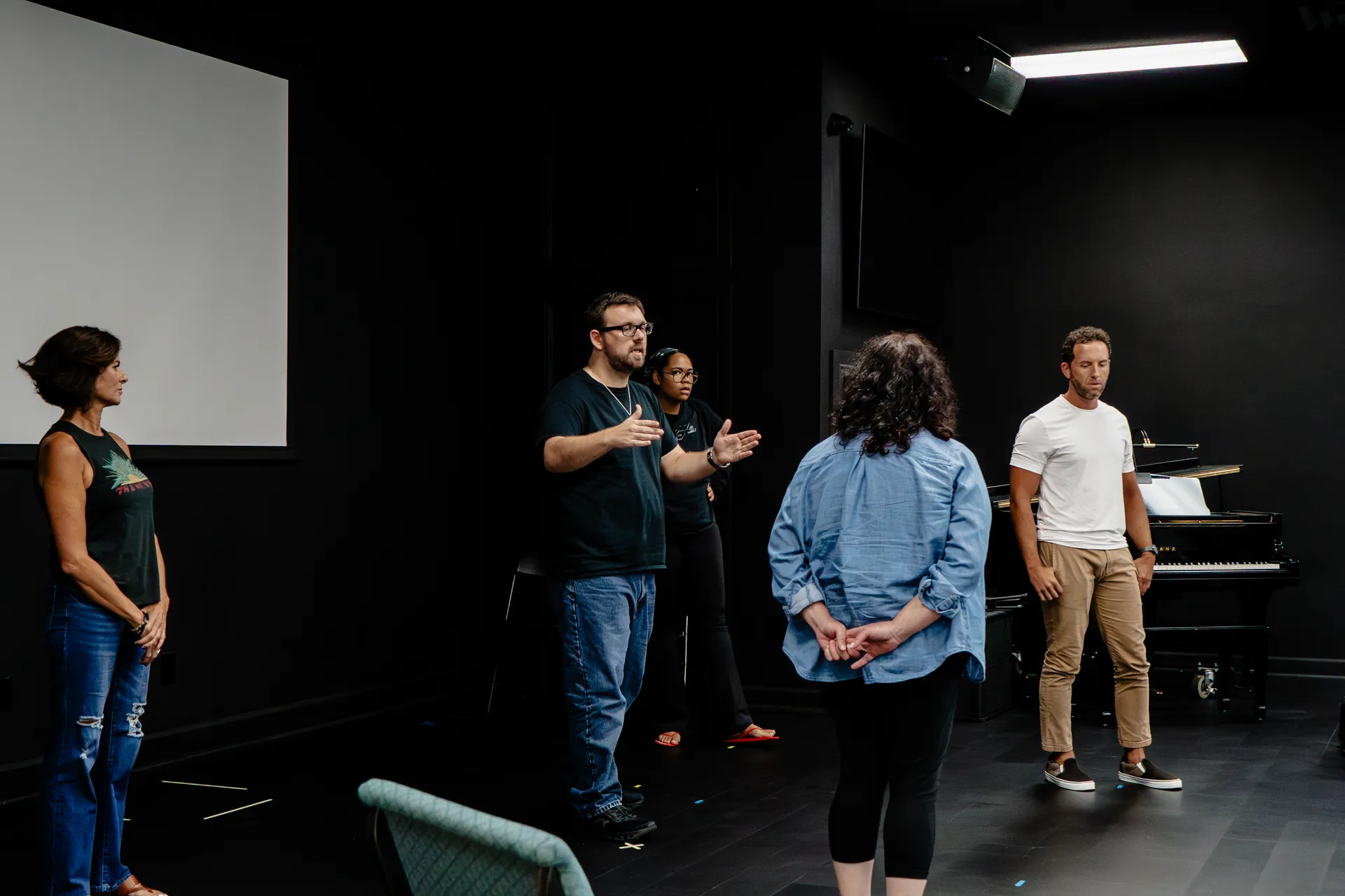 Coach Mike teaching a standing improv exercise with workshop participants on Florida's Treasure Coast